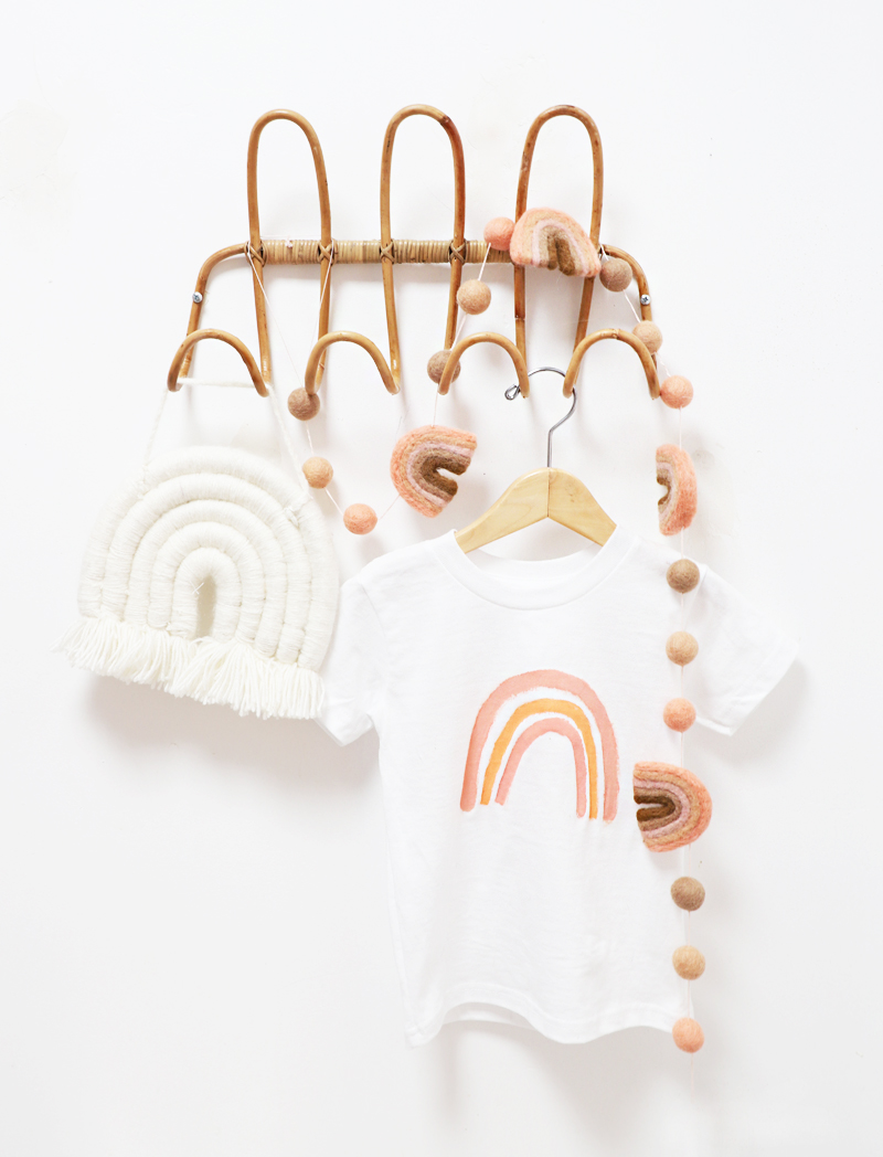toddler boho rainbow t-shirt hanging on a rack with rainbows